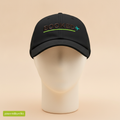 My AI Booked This Trip hat in black, embroidered with BOOKED, a plane icon and a green line, on a foam mannequin head
