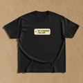 My AI Booked This Trip tee in black, printed with a small boarding pass reading MY AI BOOKED THIS TRIP, laid flat