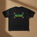 Single, Ready To Meet Vibe Coders tee in black, printed in teal and green inside cream frame corners, laid flat