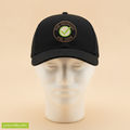 Pre-Revenue hat in black with a round PRE-REVENUE est. 2026 badge and green check mark, on a foam mannequin head