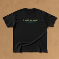 I Sold An App tee in black, printed with i sold an app and -m shipped it in code style lettering, laid flat on a tan background