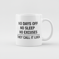 Grind Stencil mug in white, printed with NO DAYS OFF NO SLEEP NO EXCUSES THEY CALL IT LUCK in black stencil lettering