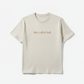 Quiet Luck fitted tee in cream, printed with they call it luck in small rust colored serif lettering, laid flat