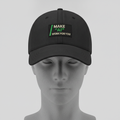 Make AI Work For You hat in black with a MAKE AI WORK FOR YOU patch in cream and green, shown on a gray mannequin head